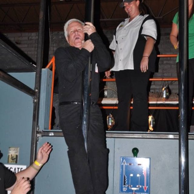 Sliding down the bat pole at Charles Keller's Batcave in Phoenix